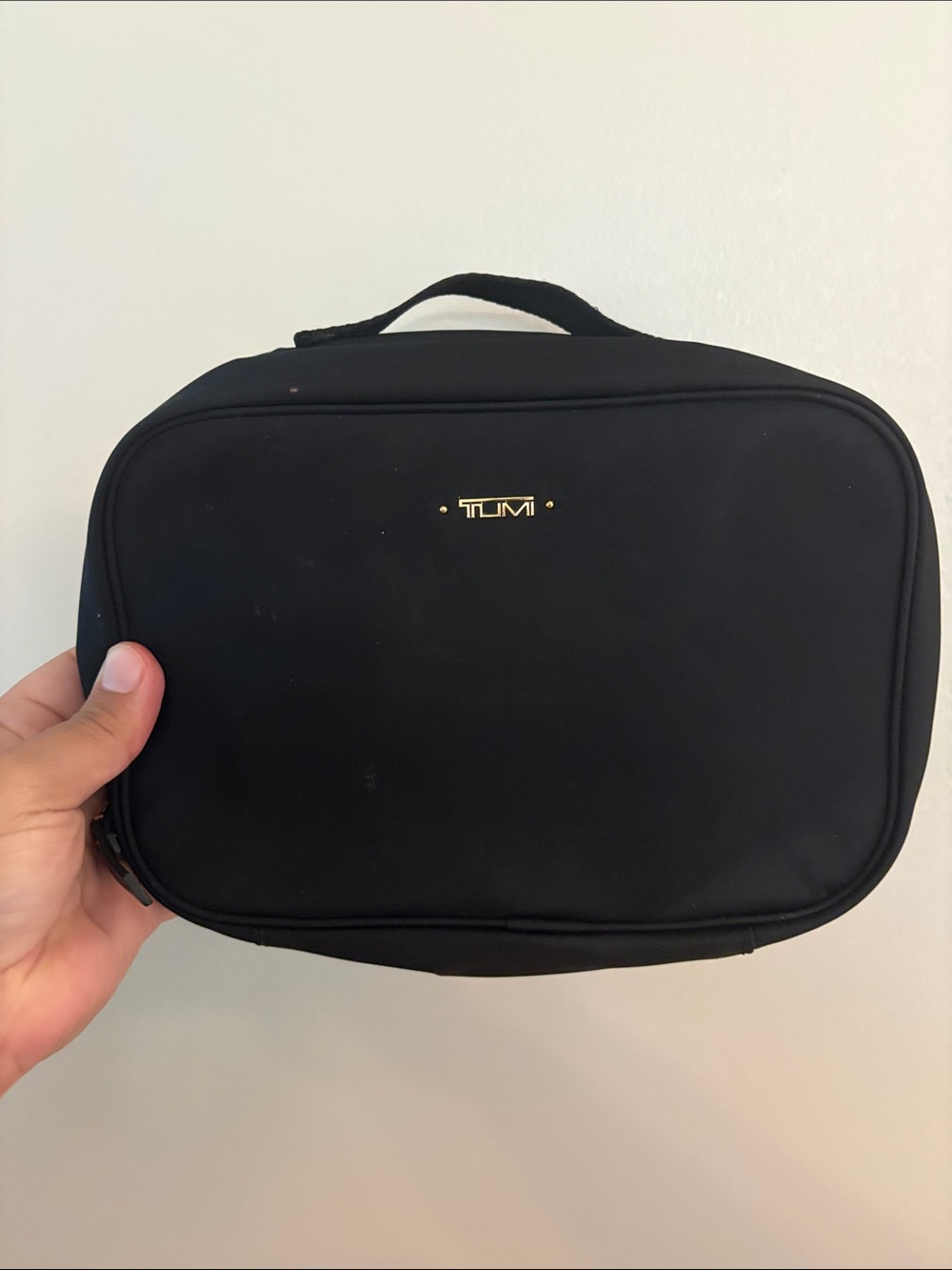 Black TUMI cosmetic travel case